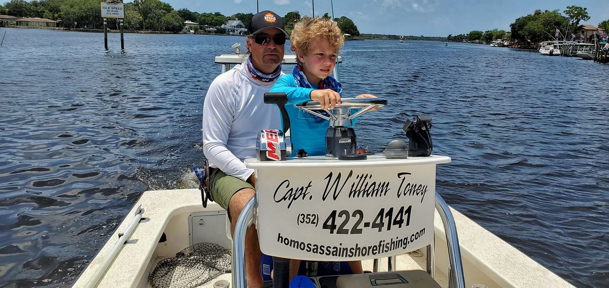 Captain William Toney at the console of his 23-foot Tremblay flats boat
